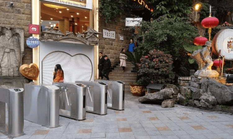 What is the function of ticketing tripod turnstiles in the scenic spot and how does it work?